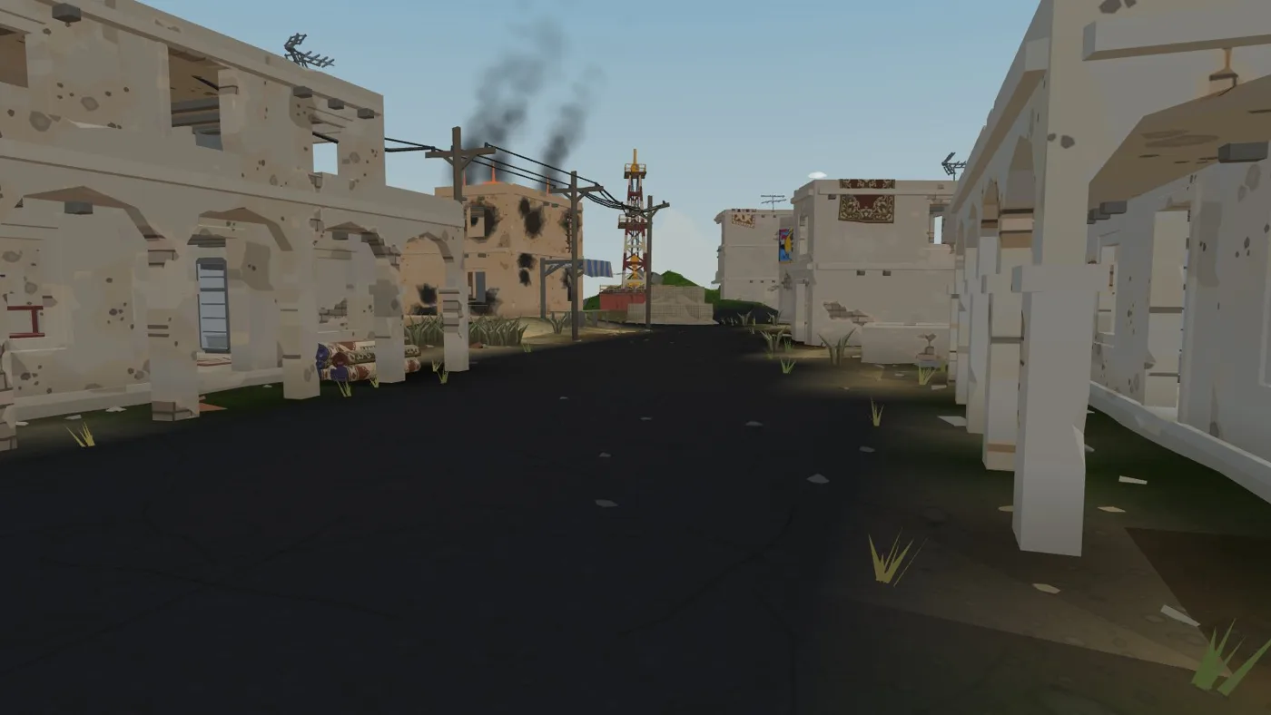 A ruined desert street with smoke in the distance
